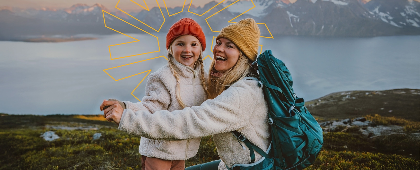 Mother and daughter smiling in the mountains